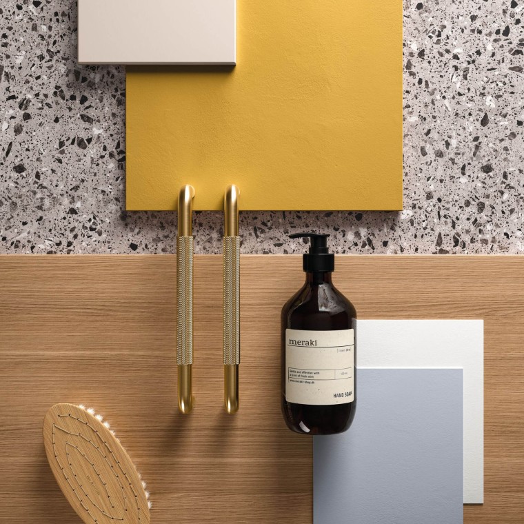 Ett gult badrum med detaljer i mässing och guld